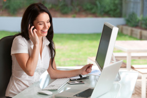 Photo of woman on computer and phone